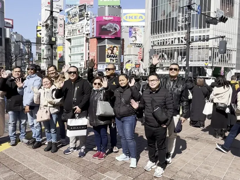 Our Japan tour group waving at the Shibuya crossing in Tokyo